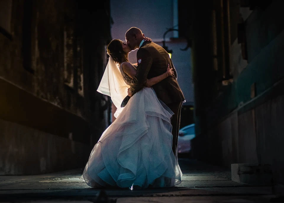 a man and woman kissing on a street