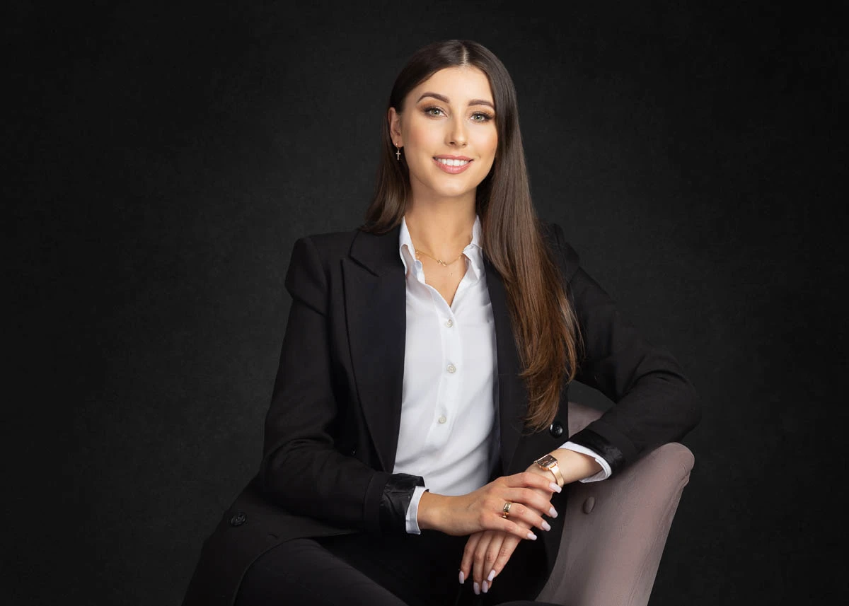 a woman in a suit sitting in a chair