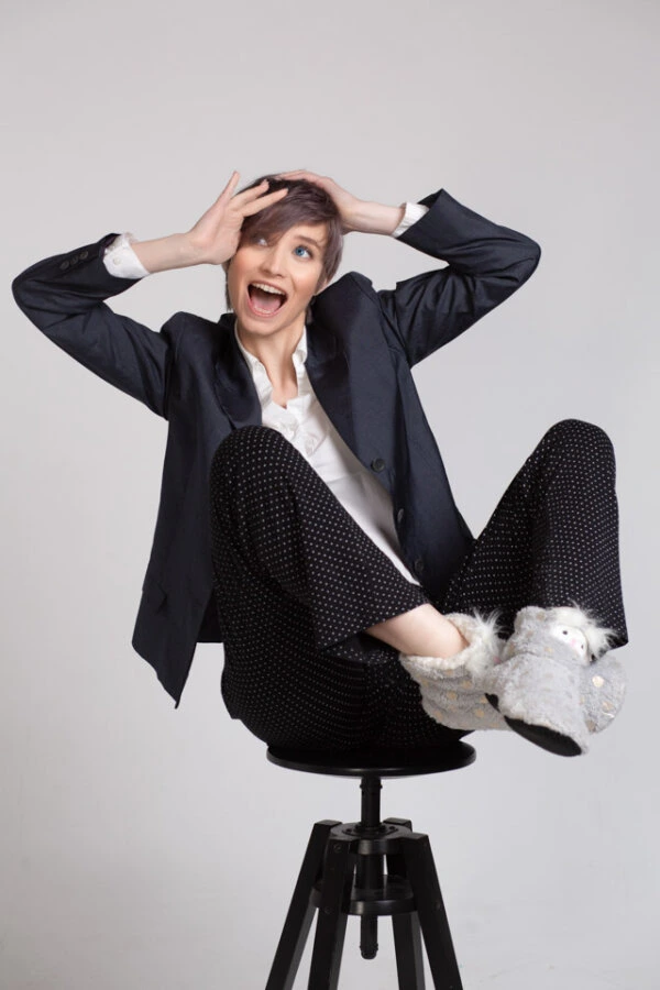 a woman sitting on a stool with her legs crossed, funny photo
